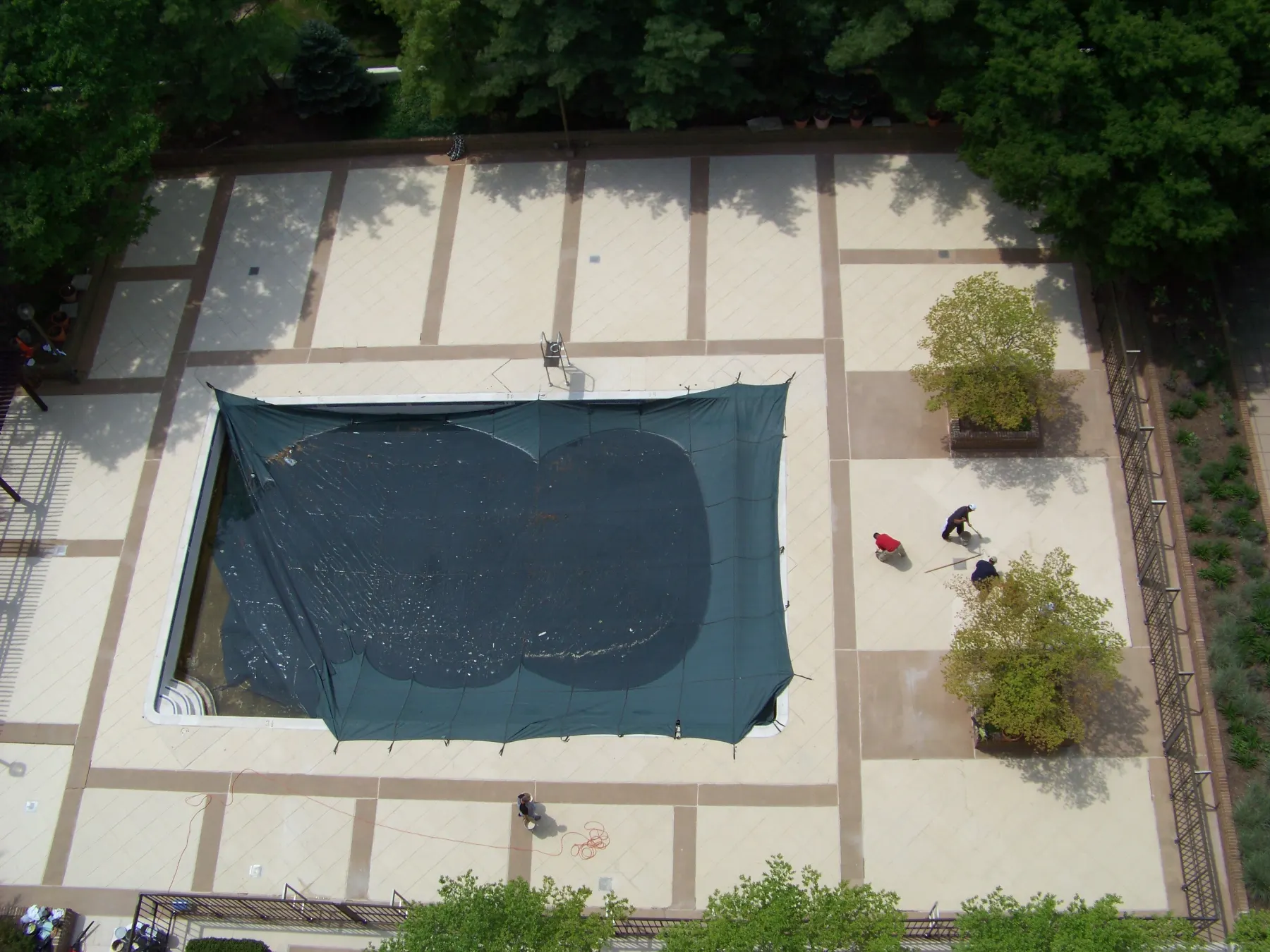 Aerial view of workers finishing a pool deck
